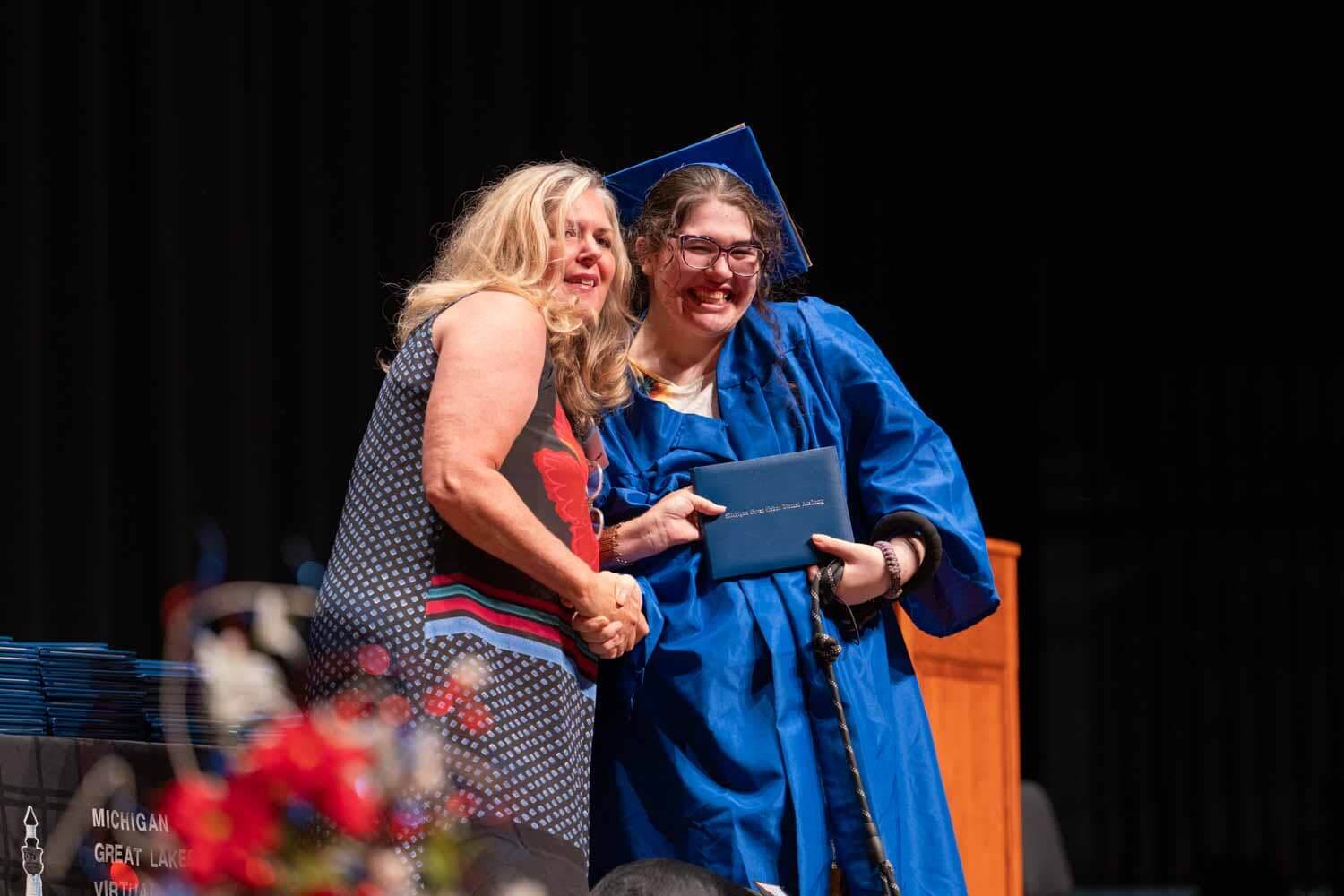 student and teacher at graduation